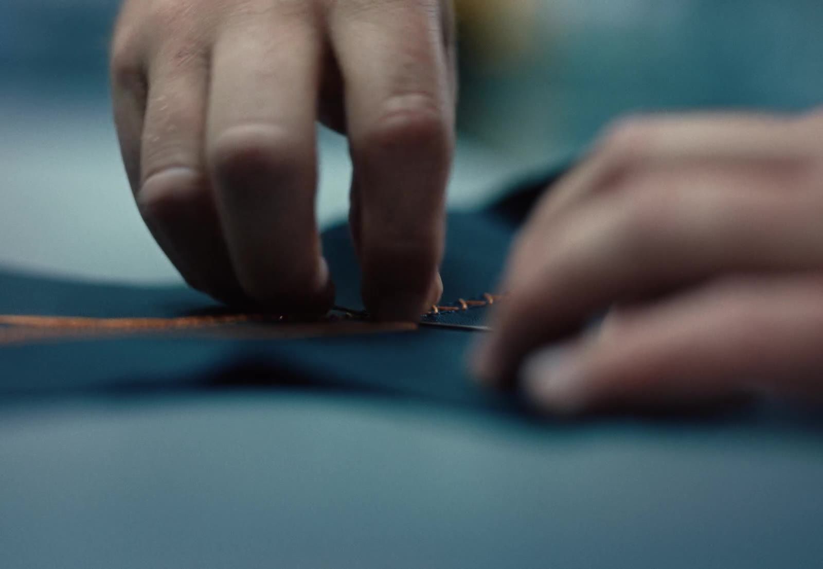 A Bentley colleague hand-stitching leather